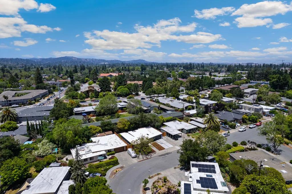 A second aerial over Atherwood showing flat and low-slope roofs, a cul-de-sac and surrounding neighbourhoods.